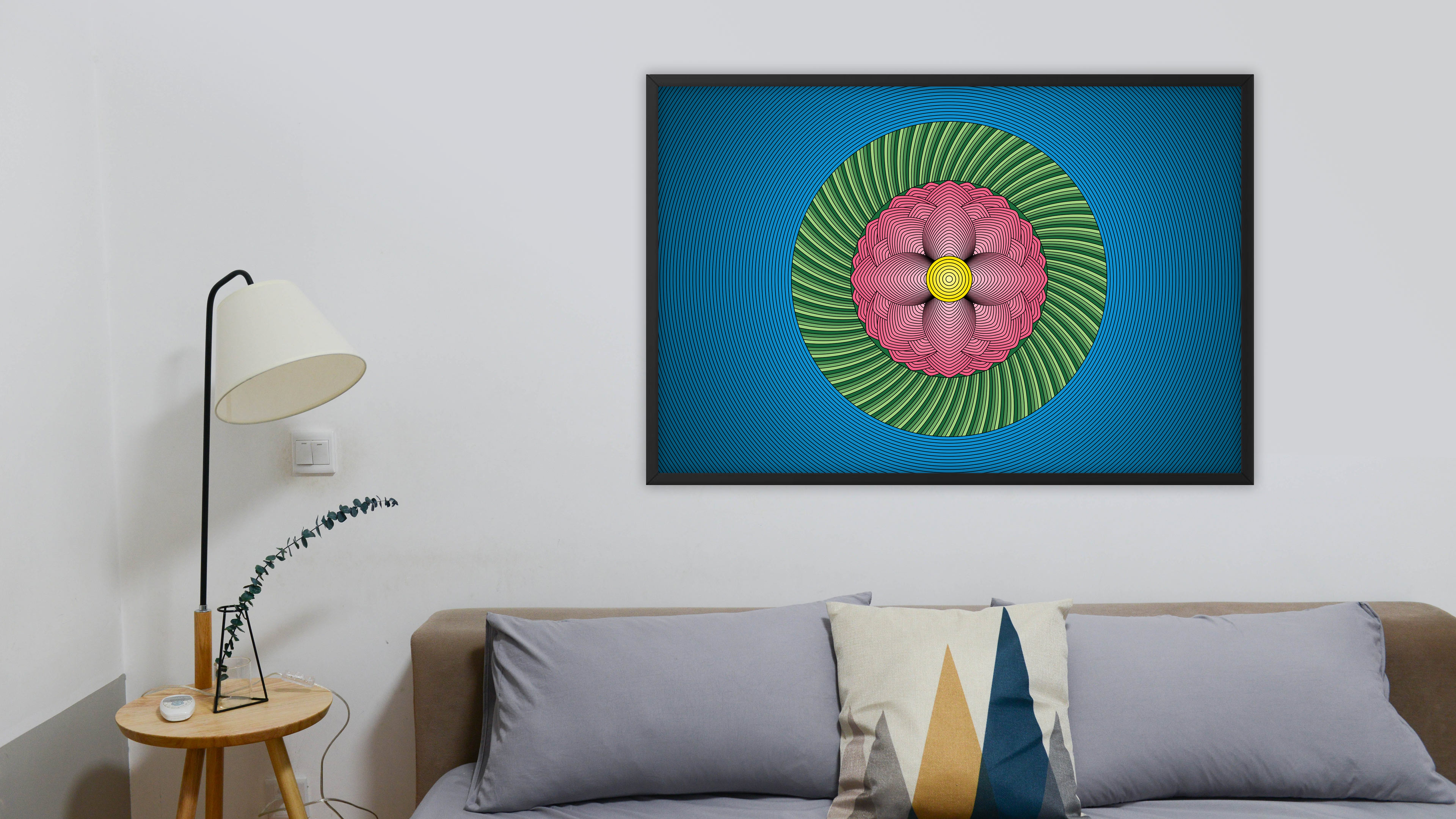 Photo of a large Lotus Flower art print in a black frame hanging on a wall over a sofa.