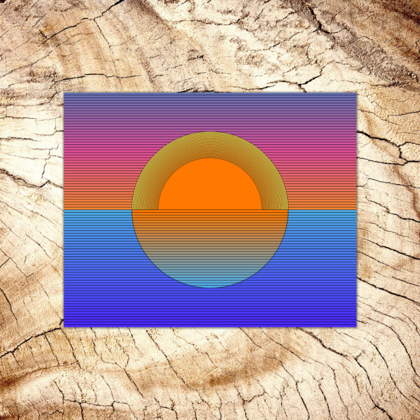 Photo of a Sunset art print laying on a wood table.